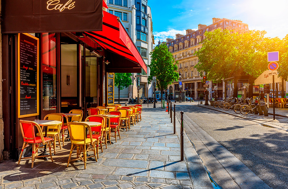 Cozy street with tables of cafe in Paris, France