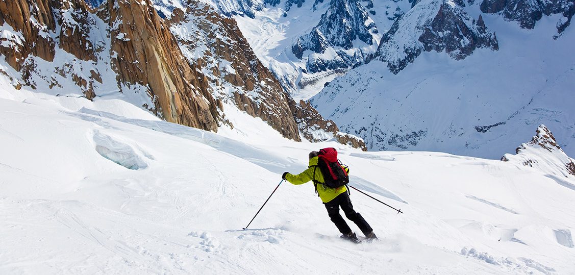 Male skier moving down in snow powder; envers du plan, vallèe blanche, Chamonix, Mont Blanc massif, France, Europe.