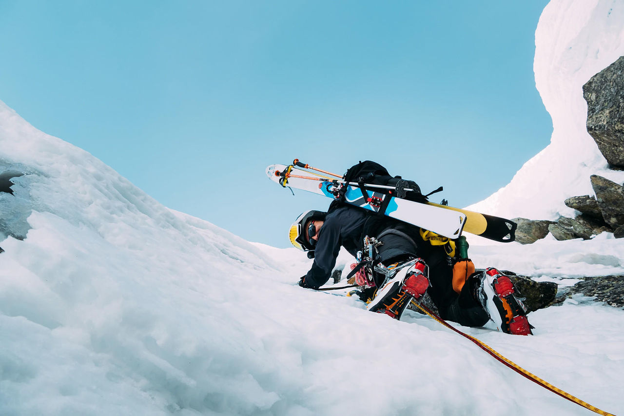 Mountaineer on a route of snow and rock during the winter. Western Alps, Italy, Europe